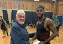 Rockets Chairman Gary Johnson presents player of the game Nick Richards with his award following his 30 points and eight rebounds
