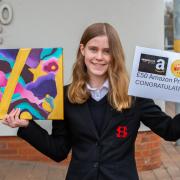 Sophia May with her winning art piece and her Amazon gift voucher.