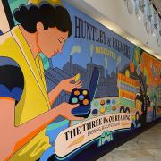 A work by the Global Street Art team from London celebrating the three Bs of Reading: brewing, biscuits and bulbs at the riverside level l of The Oracle shopping centre. Credit: Local Democracy Reporting Service