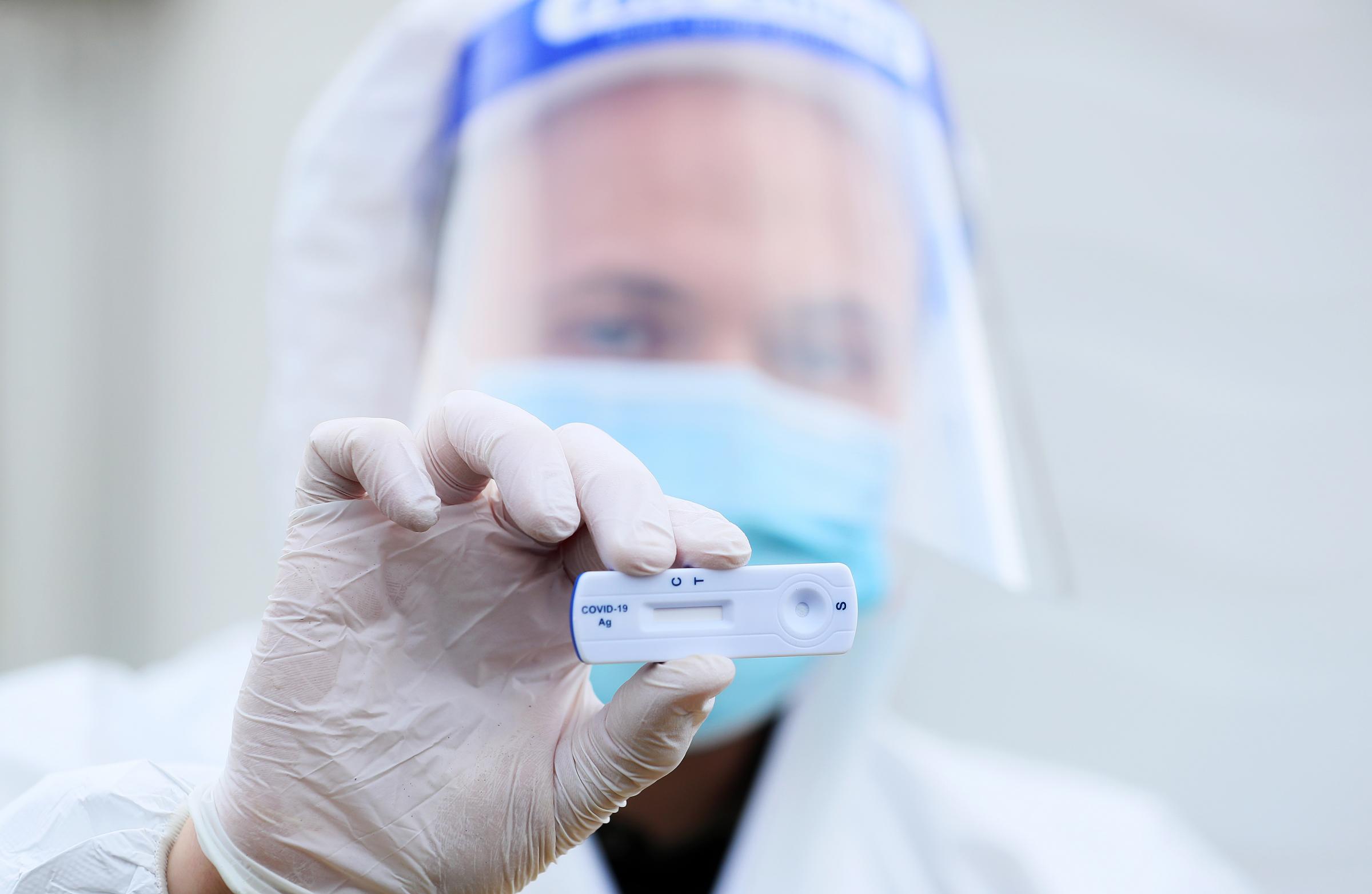 A lab technician holds a Healgen Covid-19 Rapid Antigen Test at RocDocs testing facility in Gorey, Co. Wexford, for lorry drivers bound for France. The healthcare company has signed a contract with the Department of Transport to provide rapid Covid-19