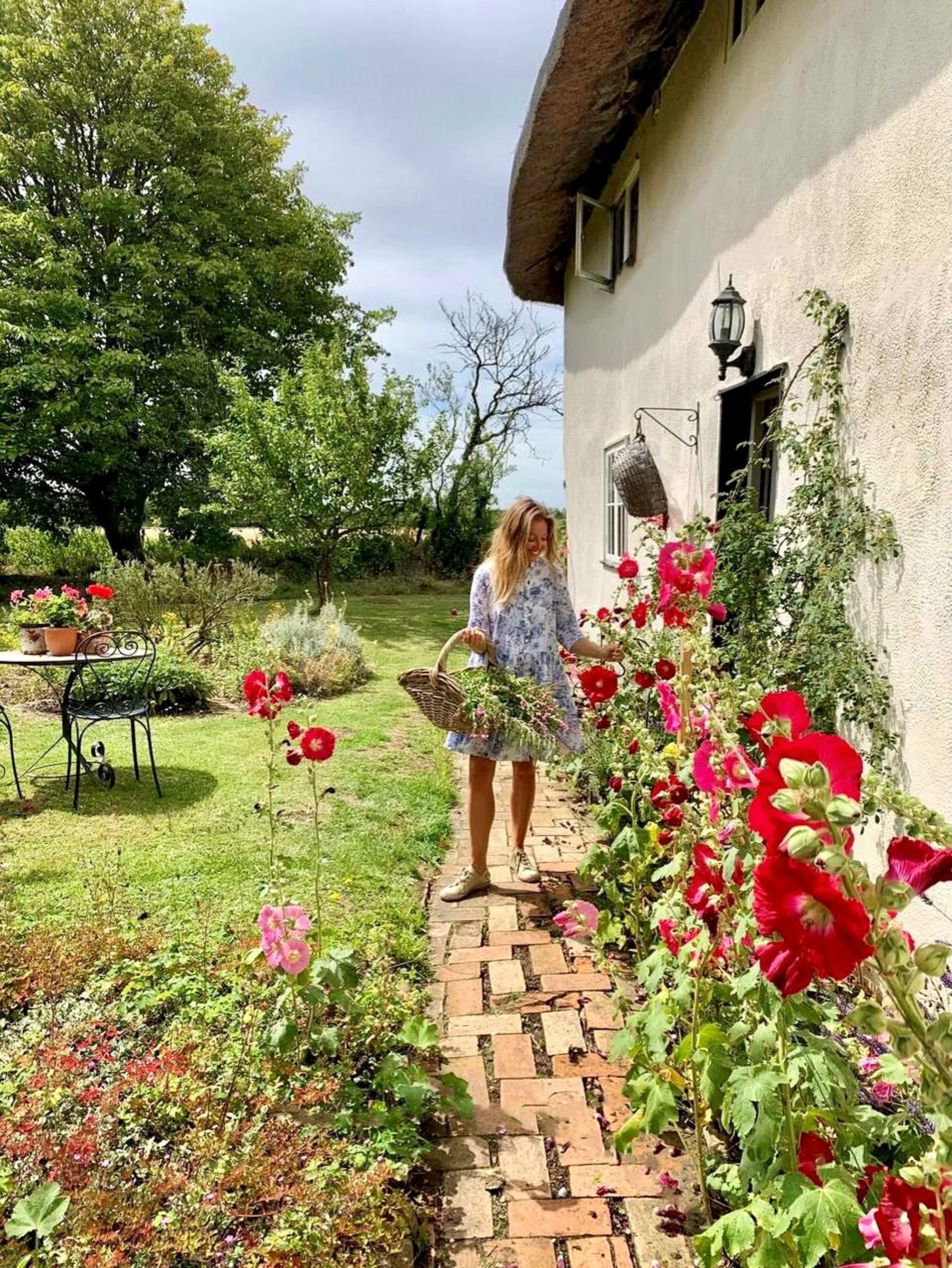 Undated handout Photo of Rebecca Lovatt outside her English country cottage. See PA Feature HOMES Cottagecore. Picture credit should read: Rebecca Lovatt/PA. WARNING: This picture must only be used to accompany PA Feature HOMES Cottagecore. 
