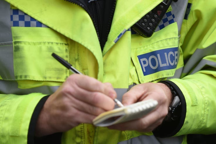 Masked man in pink gloves threatens betting shop staff at gunpoint