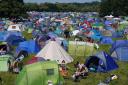 Music fans by their tents at Latitude festival. Credit: PA