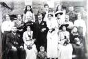 A family wedding, with Ellen sitting on the far right of the front row and her husband Mark Blackall on the far left, c.1915.