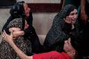 Palestinians mourn a relative killed in the Israeli bombardment of the Gaza Strip (Saher Alghorra/AP)
