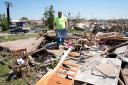 Mitch Ernst, of Adair, Iowa, sorts through debris from his mother-in-law’s tornado damaged home, Thursday, May 23, 2024, in Greenfield, Iowa (Charlie Neibergall/AP)