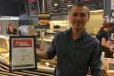 Adam Agirbas, manager of Boswells, proudly holds his award as the leader of the best cafe in Reading