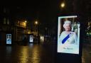 Broad Street, Reading, where the electronic billboards display an image of the Queen following her death