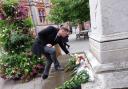Council leader Jason Brock lays flowers in memory of Queen Elizabeth II at the statue of Queen Victoria in the Town Hall Square. Credit: Reading Borough Council