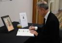 Matt Rodda, the Labour MP for Reading East, signs the Book of Condolences at Reading Town Hall. Credit: Office of Matt Rodda MP