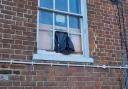 The missing window panel secured by a bin bag at the home near Reading town centre. Credit: Rochelle Bennett
