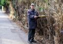 Neighbours angry after man 'hacks' away at foliage on busy road