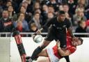 New Zealand All Black Waisake Naholo, left, fends off a Welsh defender during their rugby union test match in Auckland, New Zealand, Saturday, June 11, 2016. (Greg Bowker/New Zealand Herald via AP) NEW ZEALAND OUT, AUSTRALIA OUT.