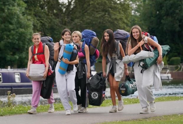Reading Chronicle: A group of girls walk along the Thames to the gates, Reading Festival 2021