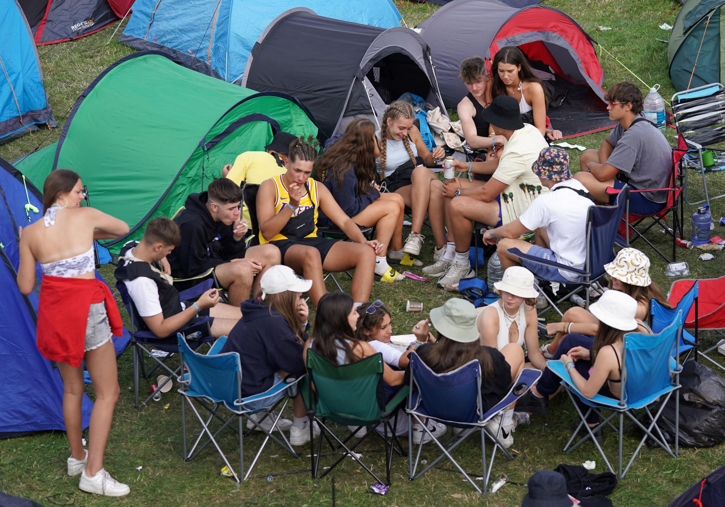 Festival goers relaxing by their tents at the Reading Festival at Richfield Avenue. Picture date: Thursday August 26, 2021. PA Photo. Photo credit should read: Kirsty OConnor/PA Wire.