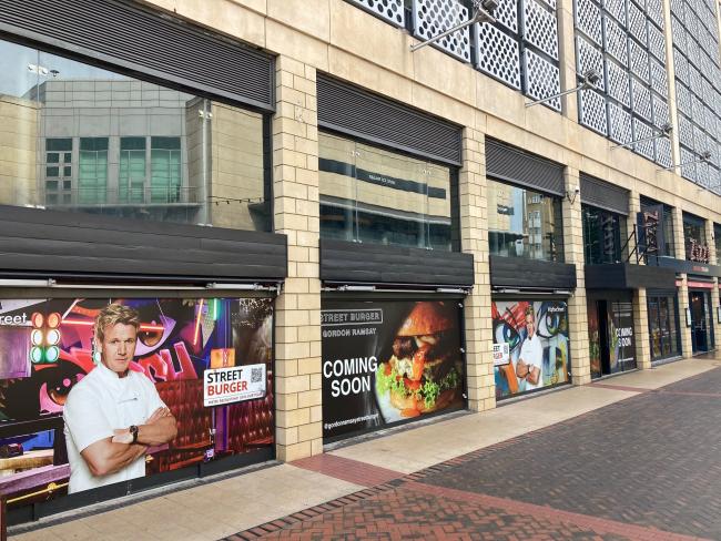 Posters advertising Gordon Ramsay's Street Burger appear in Reading town centre.