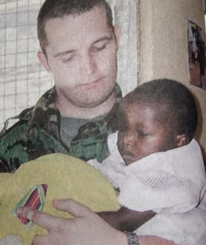Marc Stannard with an orphan in Kenya 