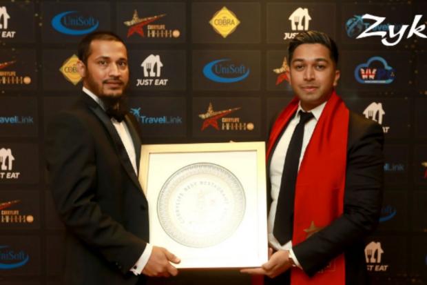 Polash Ahmed and Zak Khan, owners of Zyka restaurant in Reading, collect a Curry Life award for Best Curry Restaurant of the Year // Photograph taken by Curry Life