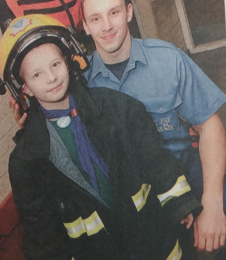 Luke Ferns with one of the firemen