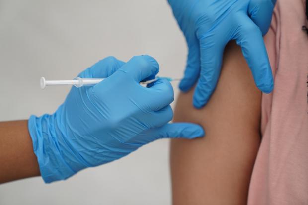 A person being injected with the Covid-19 booster vaccine. Credit:PA