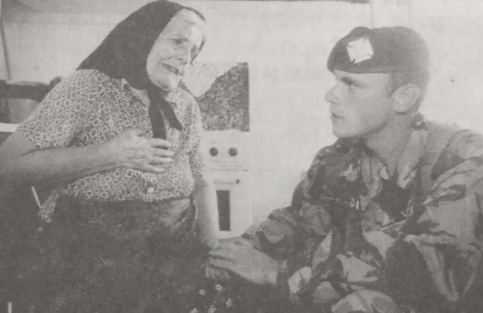 One of the residents in Kosovo with a soldier 