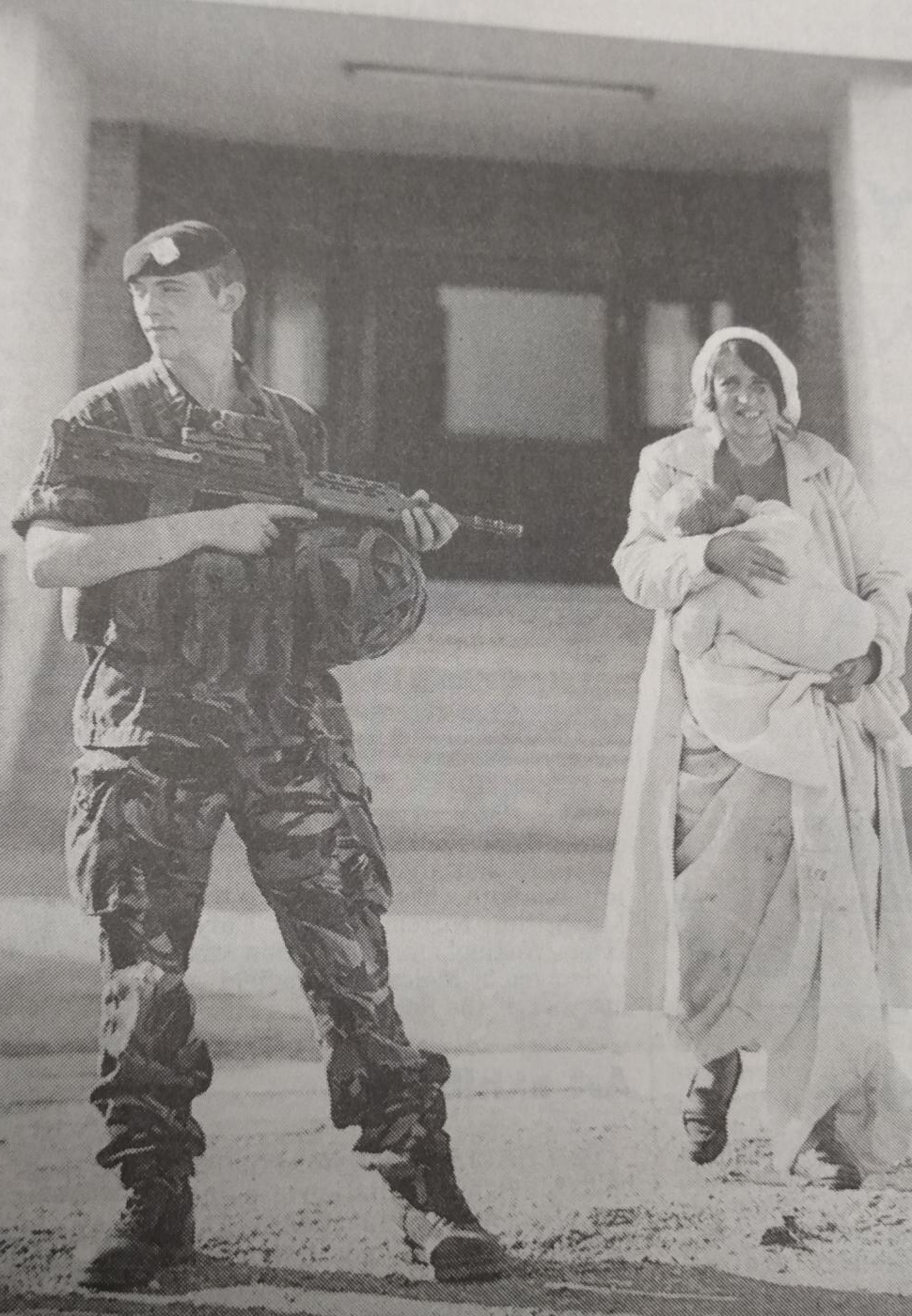 A soldier with a Kosovian woman during the war 