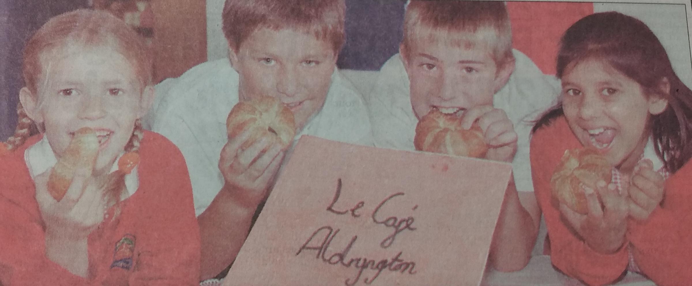 Several students eating French food to celebrate Bastille Day in 1999 