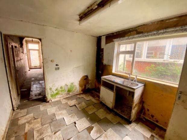 Reading Chronicle: The kitchen area of 2 The Grove in Reading, in a poor state of repair. Credit: Weston Co Architects