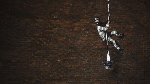 Reading Chronicle:  Banksy's 'Create Escape' painted on the outer wall of Reading Prison