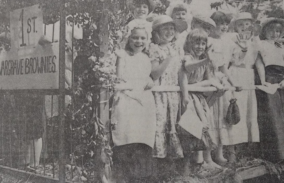 Children are seen waving at Robert Morley at the parade 