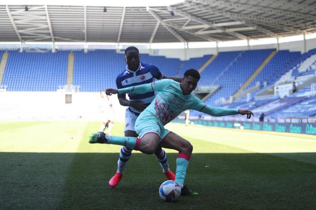 Reading Chronicle: Meite goes to battle against Swansea City in front of a Covid-enforced empty SCL. Image by: PA