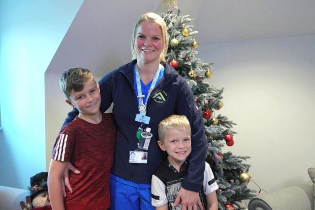 Left to right: Theo, his mum Abi, and brother Eden from Woodley