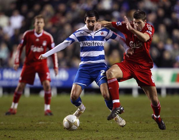 Reading Chronicle: Jem Karacan battles for the ball with Liverpool's Steven Gerrard. Image by: PA