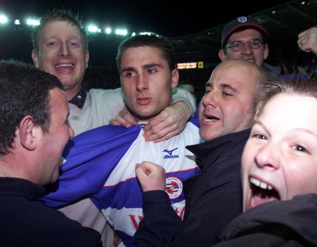 Reading Chronicle: Nicky Forster is mobbed by Reading fans after scoring a late late winner against Wigan. Image by: PA