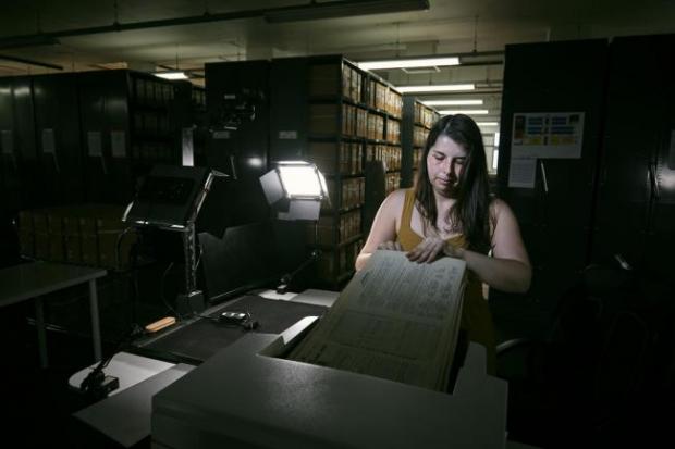 Reading Chronicle: Photo via PA shows Findmypast technician Laura Gowing scans individual pages of the 30,000 volumes of the 1921 Census at the Office for National Statistics (ONS) near Southampton.