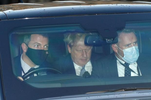 Prime Minister Boris Johnson (centre) leaves Houses of Parliament in Westminster, London, as public anger continues over 'partygate'