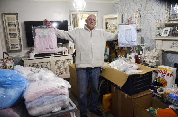 Reading Chronicle: Ronnie Goodberry holds two baby blankets, donated to him brand new last week