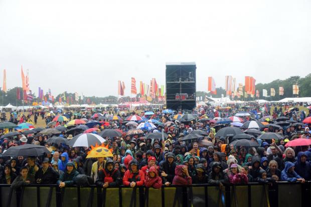 Reading Chronicle: Festival crowds in the rain. Credit: PA