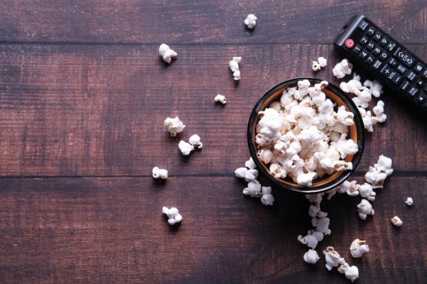 Reading Chronicle: A bowl of popcorn and a TV remote (Canva)