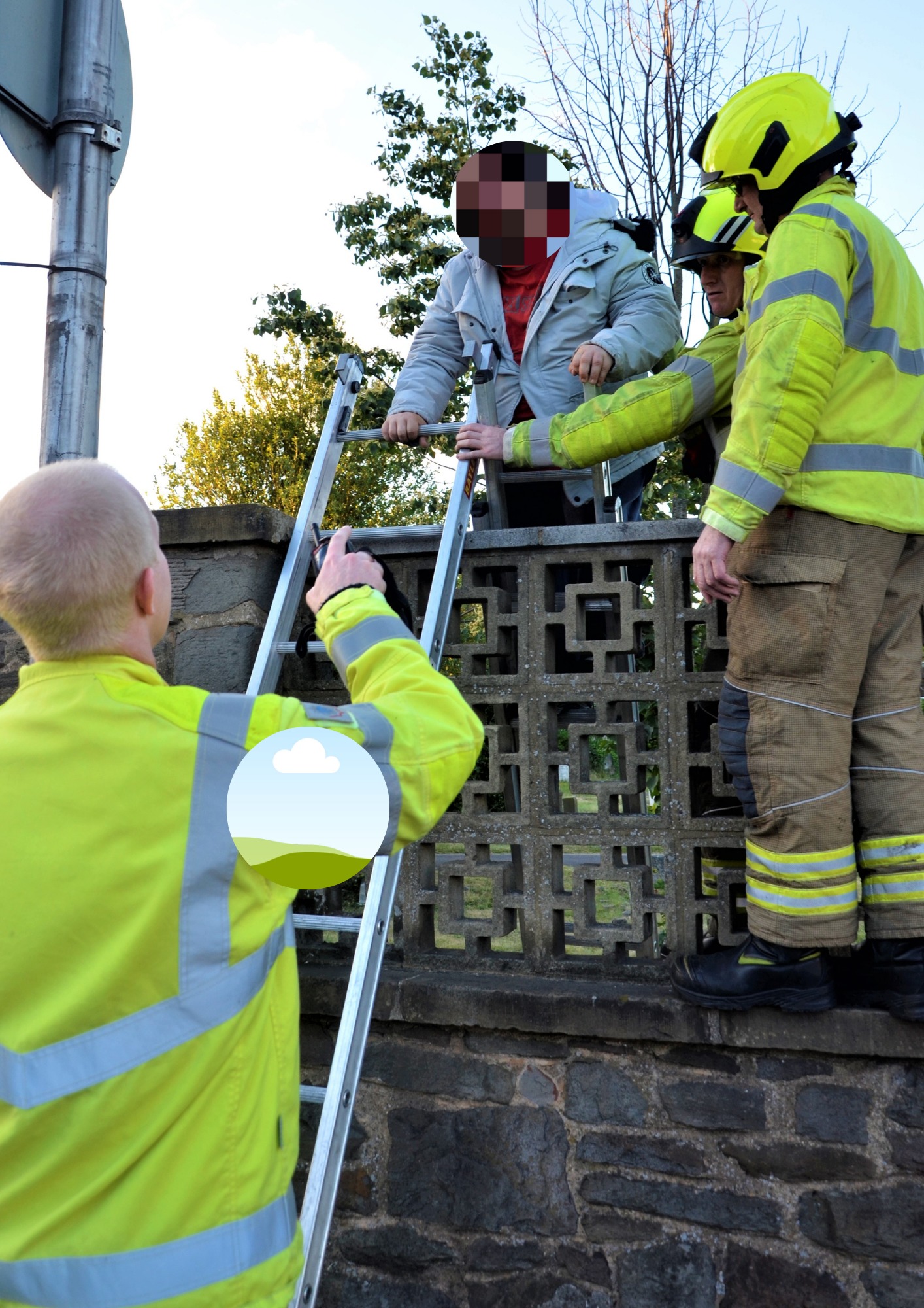 Firefighters help a man out of Reading Old Cemetery after he was locked in. Images via Paul King