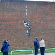 The Banksy mural on the wall of Reading Prison
