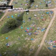 The site of Reading Festival littered tents and rubbish that have been left behind by revellers at Little John's Farm, captured in footage shot by flyskydrones@hotmail.com on Monday