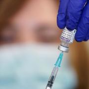 Nurse Heather Esmer draws a syringe before administering a Covid-19 vaccine booster at Birkenhead Medical Building in Birkenhead, Merseyside.
