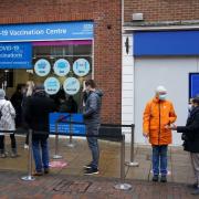 People queue at a vaccination centre on Solihull High Street, West Midlands, as the coronavirus booster vaccination programme is ramped up