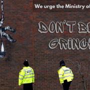 Artwork painted by Banksy on the outer wall of Reading Prison, which the street artist has pledge £10m to turn into an arts hub
