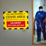 A nurse walks through a Covid ward at King's College Hospital, in south east London. Picture date: Tuesday December 21, 2021.