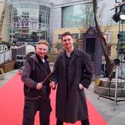 Paul Harris, wand choreographer for the Harry Potter and Fantastic Beasts franchises, and reporter Brad Young battle outside the Oracle, Reading, as part of the The Wizarding World Wand Tour
