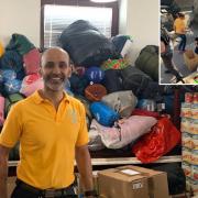Sukhminder Dhanjal, from Reading, in front of tonnes of aid collected by the Sikh temple Ramgarhia Saba,  Reading School, and Earley residents, which he delivered to Poland with eight other drivers.