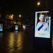 Broad Street, Reading, where the electronic billboards display an image of the Queen following her death