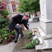 Council leader Jason Brock lays flowers in memory of Queen Elizabeth II at the statue of Queen Victoria in the Town Hall Square. Credit: Reading Borough Council